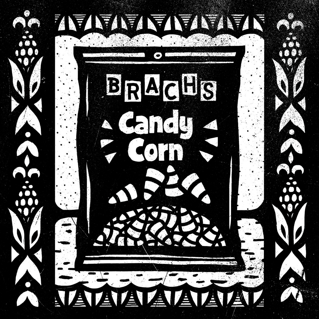An illustration of a bag of candy corn in an ornate frame.